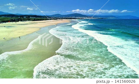 Enjoying the Beautiful and Inviting Beach Waves on a Perfectly Sunny Day at the Coast Enjoying the Beautiful and Inviting Beach Waves on a Perfectly Sunny Day at the Coast 141560026