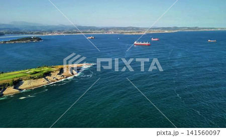 A Stunning Aerial View of a Serene Coastal Landscape Featuring Ships and Beautiful Green Shores 141560097