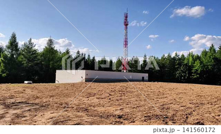 A Telecommunication Tower That is Beautifully Surrounded by a Lush Forested Area A Telecommunication Tower That is Beautifully Surrounded by a Lush Forested Area 141560172