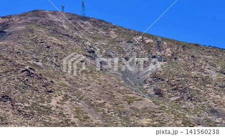 A stunning mountain landscape with communication towers, erosion, beauty, and wildlife A stunning mountain landscape with communication towers, erosion, beauty, and wildlife 141560238
