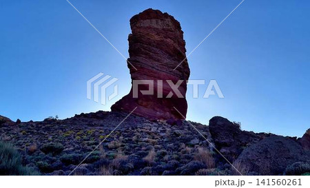 A Majestic Rock Formation Rising Against a Clear Blue Sky, Evoking Wonder and Exploration A Majestic Rock Formation Rising Against a Clear Blue Sky, Evoking Wonder and Exploration 141560261