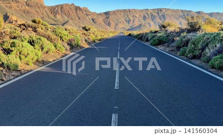 A Scenic and Empty Road That Winds Its Way Through Majestic Mountains and Lush Greenery A Scenic and Empty Road That Winds Its Way Through Majestic Mountains and Lush Greenery 141560304