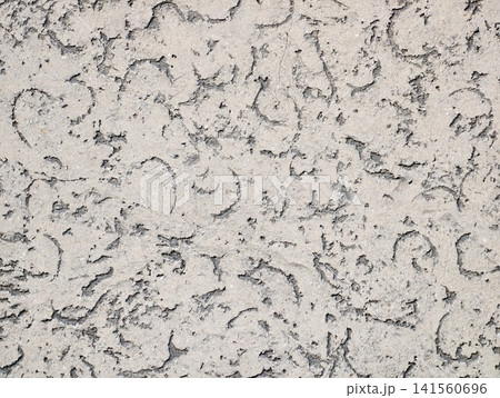 Decorative wall with subtle imperfections. Vintage style plaster with delicate cracks and mottling Decorative wall with subtle imperfections. Vintage style plaster with delicate cracks and mottling 141560696