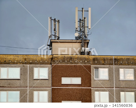 Telecommunication equipment installed on historic urban buildings under cloudy skies and mossy edges Telecommunication equipment installed on historic urban buildings under cloudy skies and mossy edges 141560836