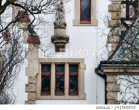 Gothic stone architecture. Architectural details on Gothic stone exteriors showcase craftsmanship Gothic stone architecture. Architectural details on Gothic stone exteriors showcase craftsmanship 141560850
