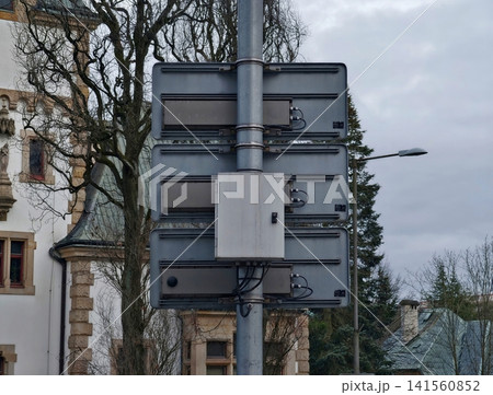 Cables and conduits near historic building. Suburban street scene with utility boxes and overcast sky Cables and conduits near historic building. Suburban street scene with utility boxes and overcast sky 141560852