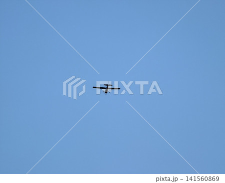 Pilot flying jet amidst calm weather. Training aircraft navigating sky with focused precision Pilot flying jet amidst calm weather. Training aircraft navigating sky with focused precision 141560869