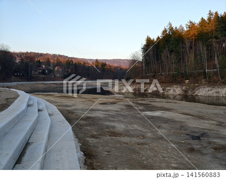 Industrial terrain with exposed mud. Site showing concrete steps alongside raw natural settings 141560883