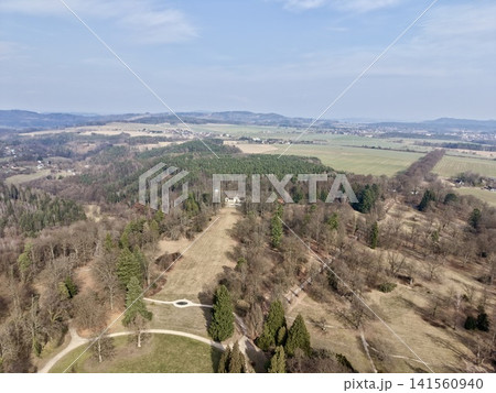 Serene forest clearing from above. Aerial perspective of tranquil woodland and open landscapes Serene forest clearing from above. Aerial perspective of tranquil woodland and open landscapes 141560940