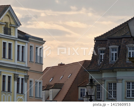 Evening cityscape scene. Soft clouds and vintage lampposts adorn tranquil evening city views 141560953