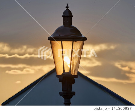 Historical street lighting illuminates dusk with nostalgic charm and intricate metal designs Historical street lighting illuminates dusk with nostalgic charm and intricate metal designs 141560957