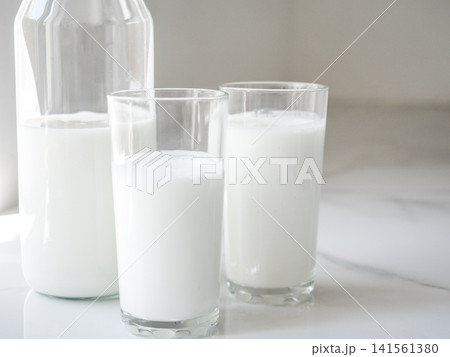Glass bottle and two glasses of fresh milk 141561380
