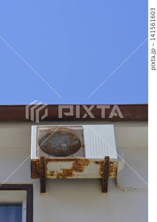 Rusty Air Conditioner Outdoor Unit on Wall 141561603
