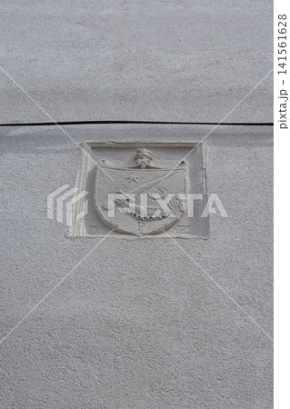 Stone coat of arms on a facade 141561628