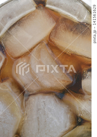 Macro shot of ice cubes in a dark drink Macro shot of ice cubes in a dark drink 141561629