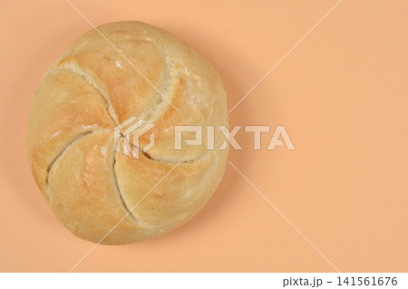 Single Kaiser Roll on Peach Background with Copy Space Single Kaiser Roll on Peach Background with Copy Space 141561676