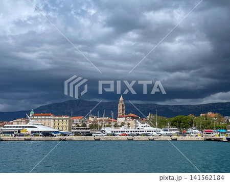 Displaying historic architecture and a bustling harbor, the split city on Croatias Adriatic coast is framed by threatening dark storm clouds Displaying historic architecture and a bustling harbor, the split city on Croatias Adriatic coast is framed by threatening dark storm clouds 141562184