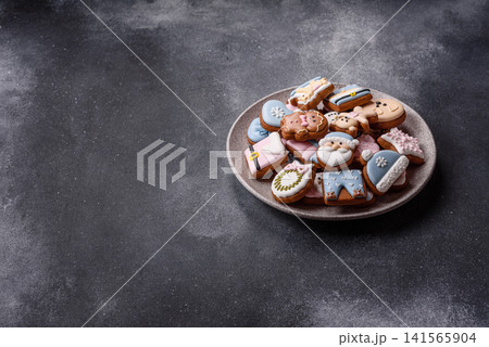Gingerbread as a Christmas staple, sweet biscuits for the holiday. Gingerbread as a background 141565904