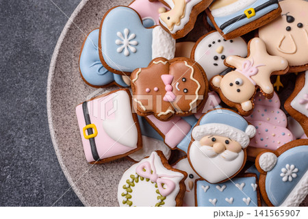 Gingerbread as a Christmas staple, sweet biscuits for the holiday. Gingerbread as a background Gingerbread as a Christmas staple, sweet biscuits for the holiday. Gingerbread as a background 141565907