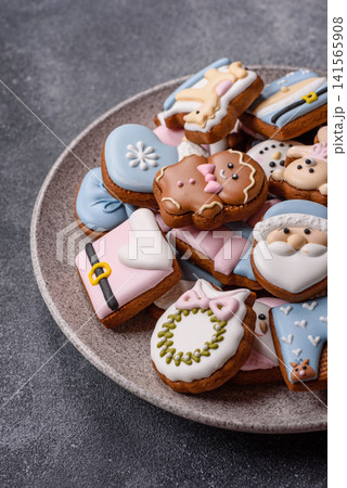 Gingerbread as a Christmas staple, sweet biscuits for the holiday. Gingerbread as a background Gingerbread as a Christmas staple, sweet biscuits for the holiday. Gingerbread as a background 141565908
