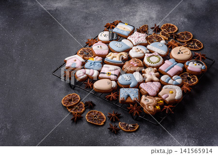 Gingerbread as a Christmas staple, sweet biscuits for the holiday. Gingerbread as a background Gingerbread as a Christmas staple, sweet biscuits for the holiday. Gingerbread as a background 141565914