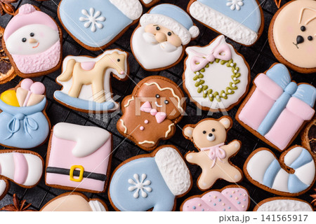 Gingerbread as a Christmas staple, sweet biscuits for the holiday. Gingerbread as a background Gingerbread as a Christmas staple, sweet biscuits for the holiday. Gingerbread as a background 141565917