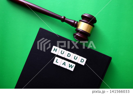 Hudud law concept with gavel and book illustrating islamic justice Hudud law concept with gavel and book illustrating islamic justice 141566033