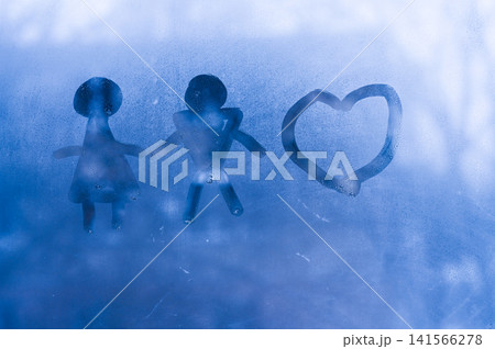 Family figures and heart symbol on wet glass create abstract background with blue tones. Family figures and heart symbol on wet glass create abstract background with blue tones. 141566278