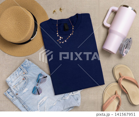 Blank dark blue folded shirt mockup with woman summer accessories, template for print on demand Blank dark blue folded shirt mockup with woman summer accessories, template for print on demand 141567951