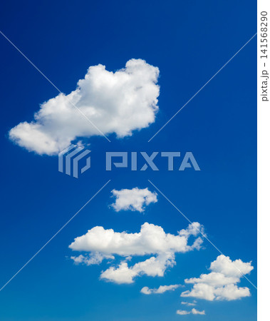 white cumulus cloud in blue sky above small cloudlets white cumulus cloud in blue sky above small cloudlets 141568290