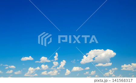 low white clouds near the horizon in a blue sky 141568317