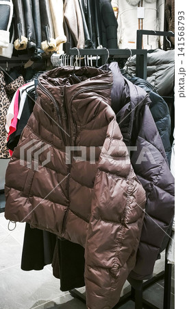 Winter jackets hanging on rack in clothing store, Winter jackets hanging on rack in clothing store, 141568793