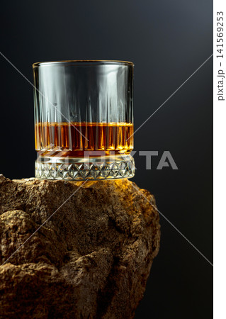 Glass of whiskey on a rough granite. Glass of whiskey on a rough granite. 141569253