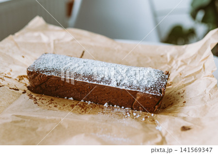 chocolate cake with powdered sugar 141569347
