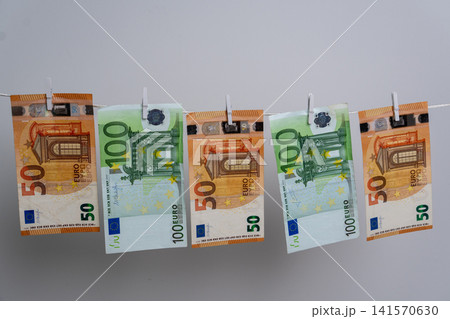 Five Euro Banknotes Hanging on Clothesline for Money Laundering Concept Five Euro Banknotes Hanging on Clothesline for Money Laundering Concept 141570630