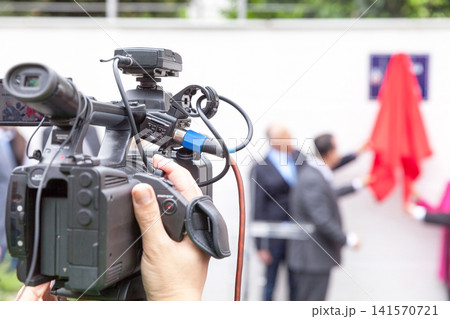 Filming media event with a video camera Filming media event with a video camera 141570721