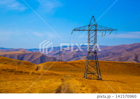 Electricity Pylons in Arid Landscape of Kyrgyzstan Electricity Pylons in Arid Landscape of Kyrgyzstan 141570960
