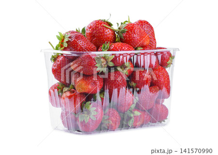 Fresh red strawberry in plastic punnet or transparent box, container isolated on white background Fresh red strawberry in plastic punnet or transparent box, container isolated on white background 141570990