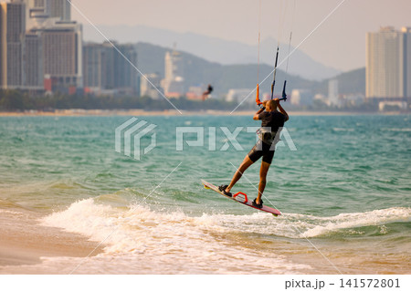 Kitesurfer returns toward shore after session in Nha Trang Vietnam Kitesurfer returns toward shore after session in Nha Trang Vietnam 141572801