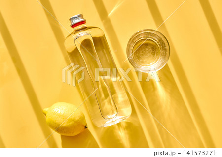 Refreshing water with lemon in bottle and glass 141573271