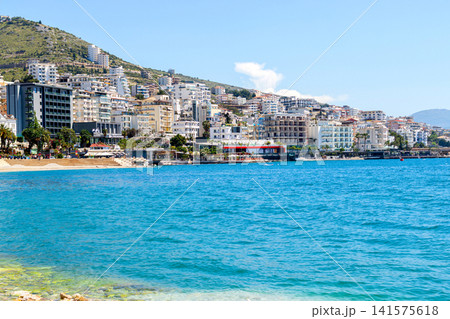 Beautiful beach with white pebbles and blue waters in european city. 141575618