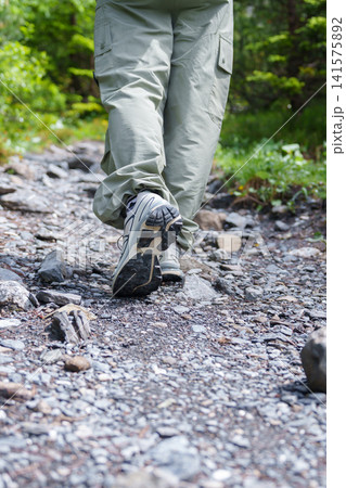 Close Up of Hiking Boots Walking on a Rocky Trail near Oeschinensee, Kandersteg, Switzerland in Summer. Outdoor Adventure in the Swiss Alps Close Up of Hiking Boots Walking on a Rocky Trail near Oeschinensee, Kandersteg, Switzerland in Summer. Outdoor Adventure in the Swiss Alps 141575892