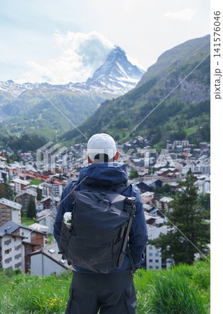 man Tourist Exploring Zermatt, Switzerland. Happy Traveler Visiting Zermatt Village Viewpoint and Matterhorn, Famous European Landmark, Popular Tourist Attraction and Travel Destination in Europe man Tourist Exploring Zermatt, Switzerland. Happy Traveler Visiting Zermatt Village Viewpoint and Matterhorn, Famous European Landmark, Popular Tourist Attraction and Travel Destination in Europe 141576046