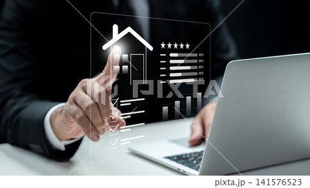 A businessman interacts with a digital screen displaying property ratings, checklists, and market charts while using a laptop. Concept of Appraiser 141576523