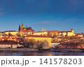 Golden Sunset Over Prague Castle and Historic Vltava River Waterfront Cityscape 141578203