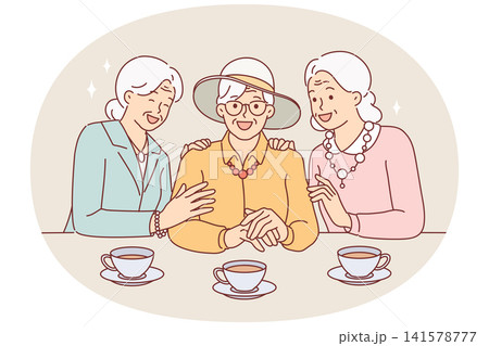 Elderly women drink tea and laugh, rejoicing at long-awaited meeting, dressed in elegant clothes Elderly women drink tea and laugh, rejoicing at long-awaited meeting, dressed in elegant clothes 141578777