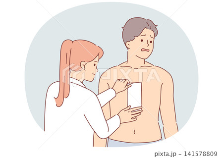 Depilation hair on chest of man, experiencing pain from tearing wax tape, stands near cosmetologist 141578809