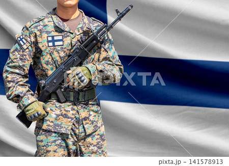Finland flag with soldier holding assault rifle Finland flag with soldier holding assault rifle 141578913