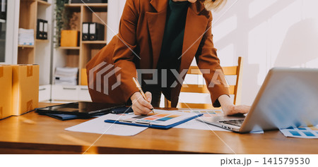Logistics, small business woman with checklist for stock, clothes order or retail inventory management. Shipping, writing or person at ecommerce startup store for sme delivery with fashion designer Logistics, small business woman with checklist for stock, clothes order or retail inventory management. Shipping, writing or person at ecommerce startup store for sme delivery with fashion designer 141579530