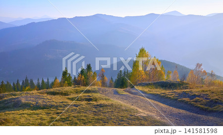 Autumn empty road in mountains in blue haze Autumn empty road in mountains in blue haze 141581598